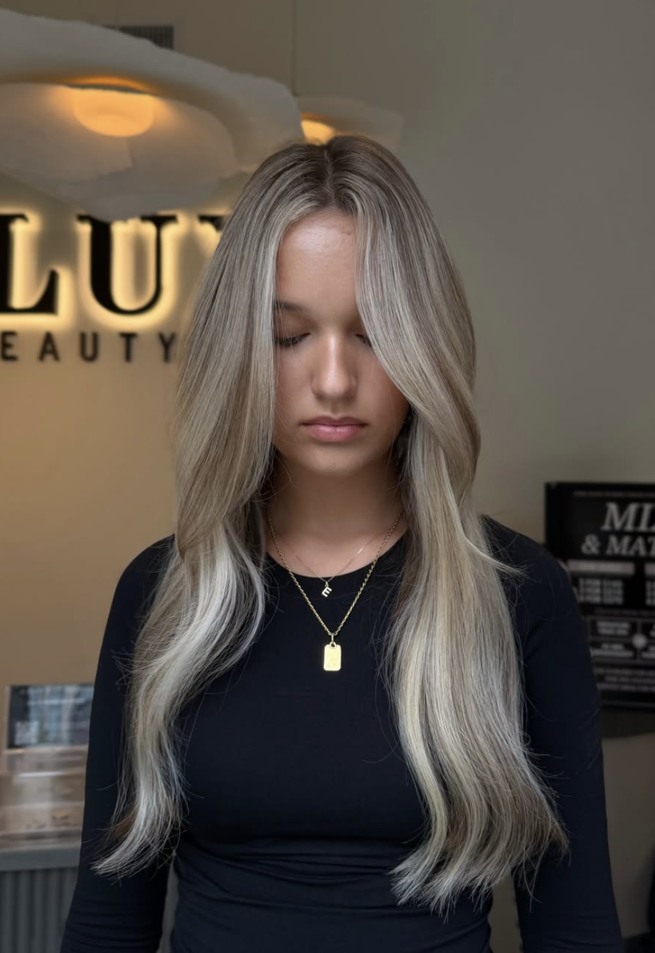 Long ash-blonde hair with soft layers and face-framing pieces at LUX Beauty Bar Hair Spa in Grimsby.